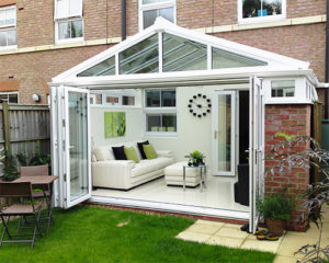 image is of a conservatory with bi-fold doors fitted